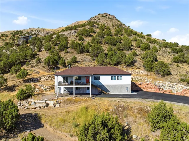 Hillside residence with a two-story design and a brown shingle roof