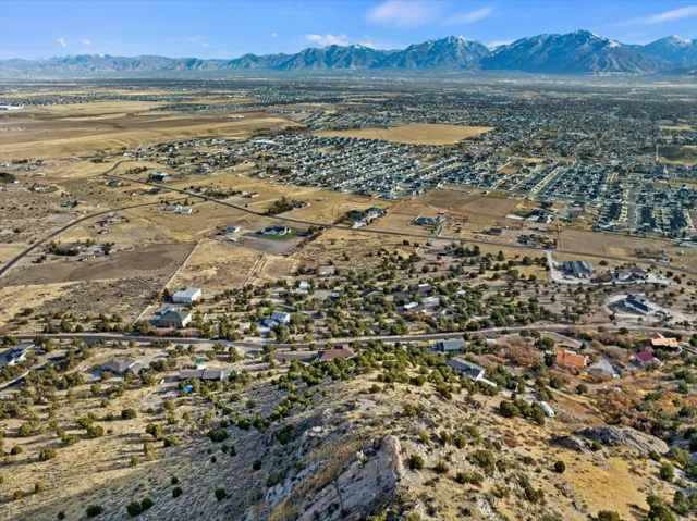 Expansive aerial showing a residential area with varied housing densities, surrounded by natural desert terrain