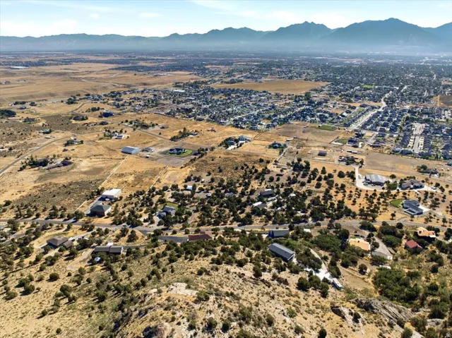 Expansive aerial landscape featuring scattered residential properties amidst natural terrain