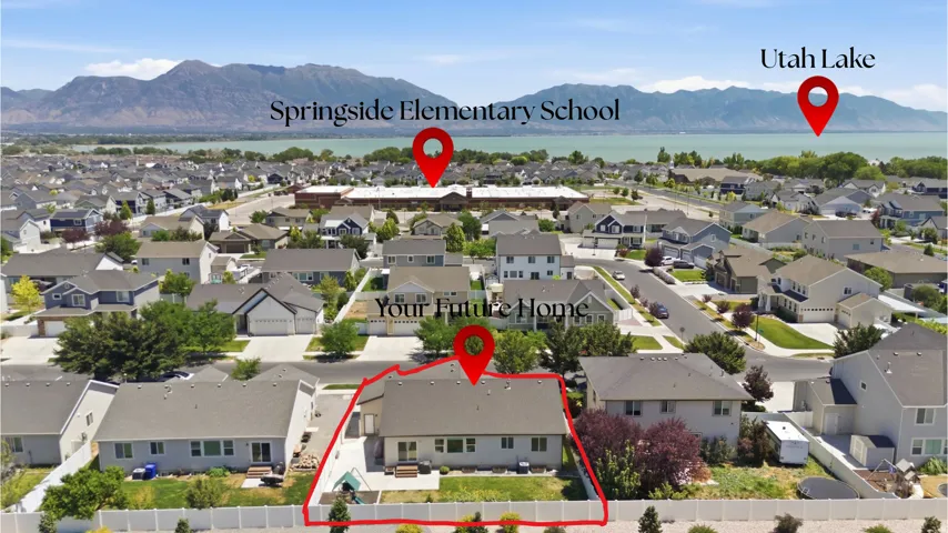 Aerial view of a residential neighborhood with a distant lake and mountains
