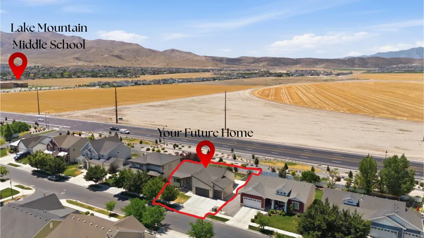 Aerial perspective showcasing a residential property with an attached garage and a concrete driveway