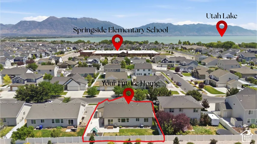 Aerial view of a residential neighborhood with a distant lake and mountains