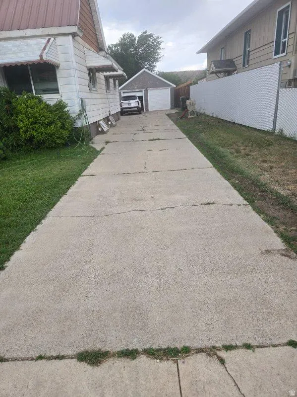 Long concrete driveway providing access to a detached two-car garage