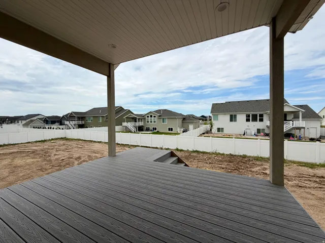 Spacious covered deck featuring composite decking and integrated steps