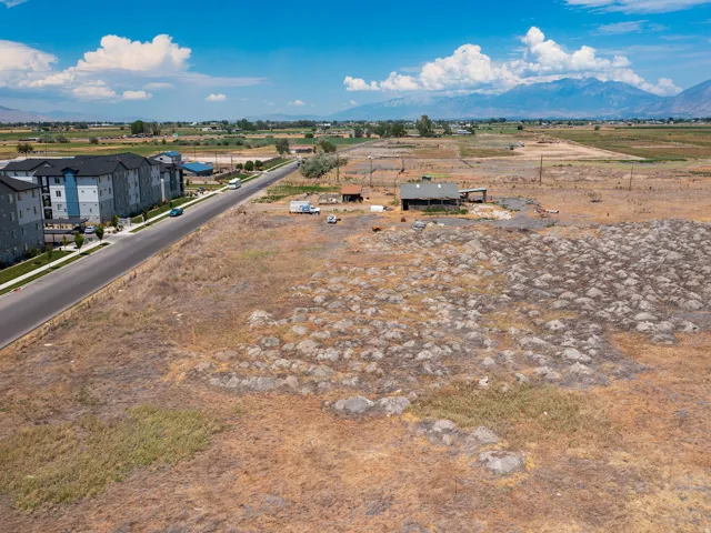 Expansive undeveloped land featuring a mix of dry grass and rocky terrain