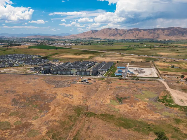 Expansive undeveloped land featuring a combination of dry grasses and sparse vegetation