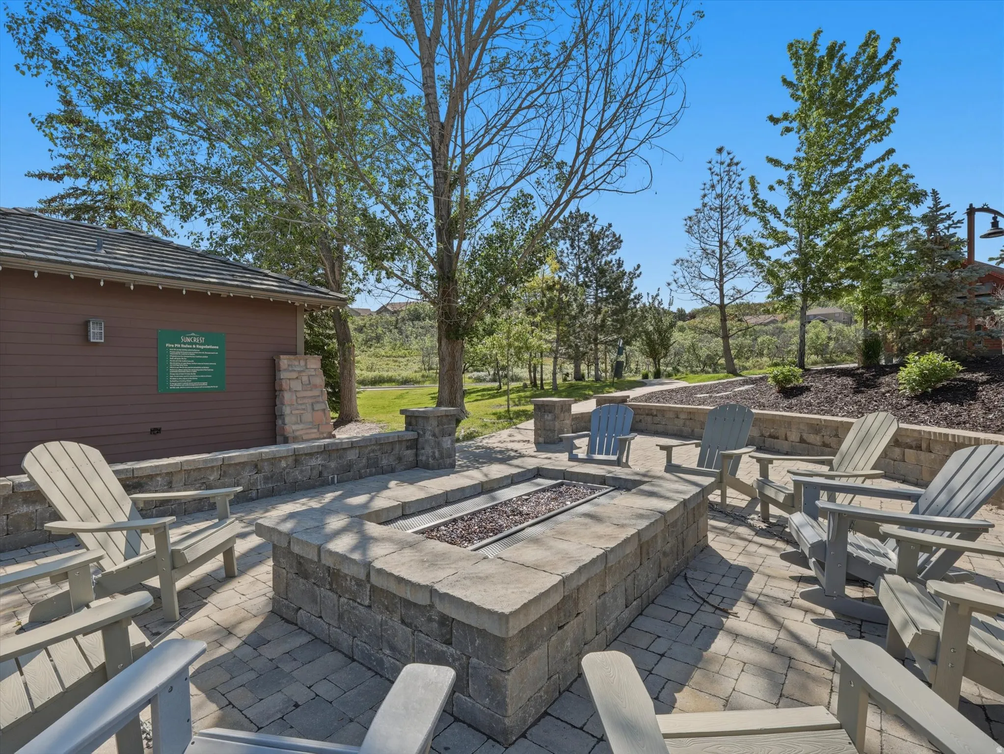 Outdoor paver patio featuring a built-in stone fire pit