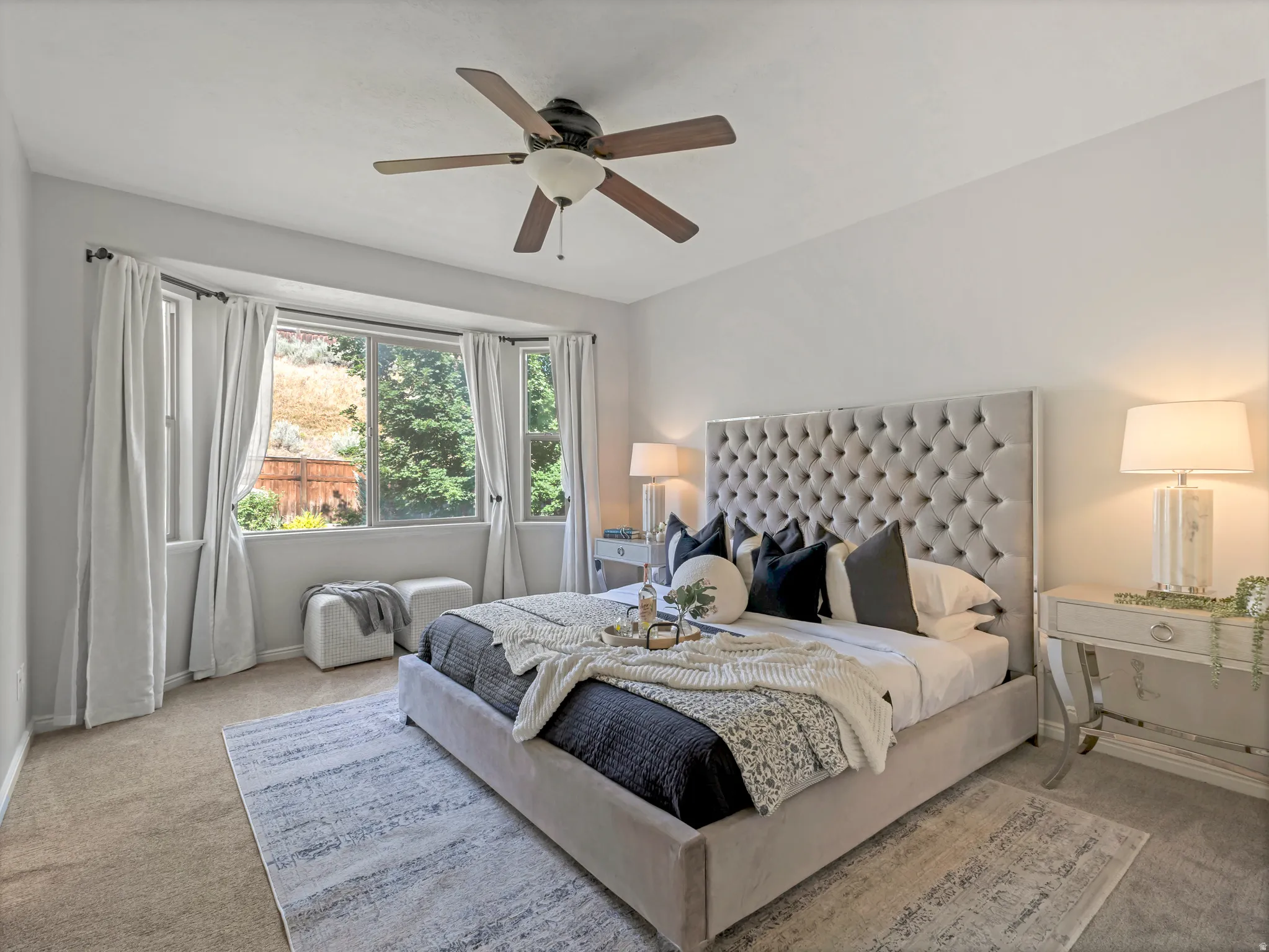 Recessed bay window with multiple panes and white drapery