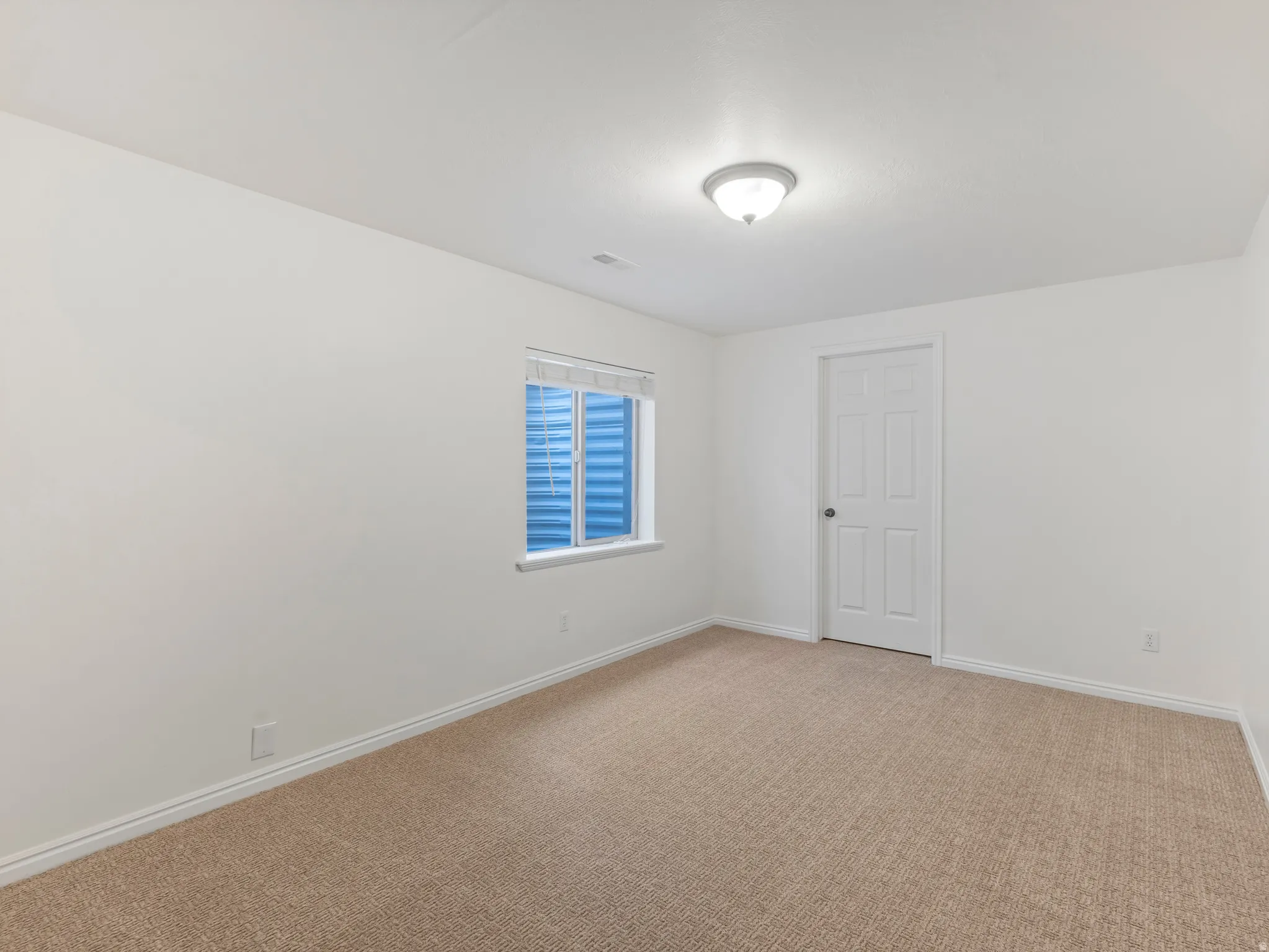Neutral-toned carpeting enhancing the bright white walls and trim