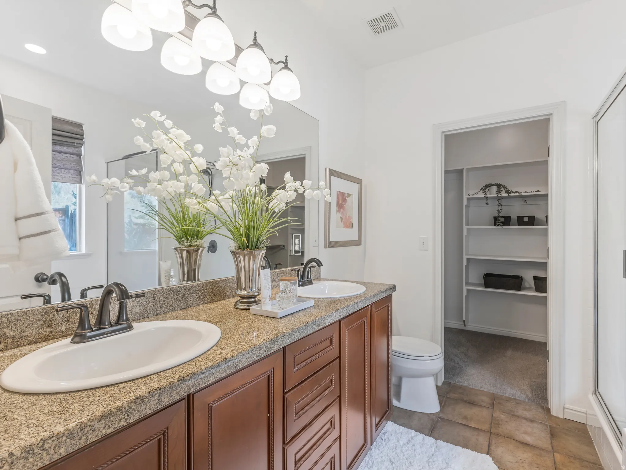Dual vanity featuring a granite-style countertop, undermount sinks, and oil-rubbed bronze fixtures