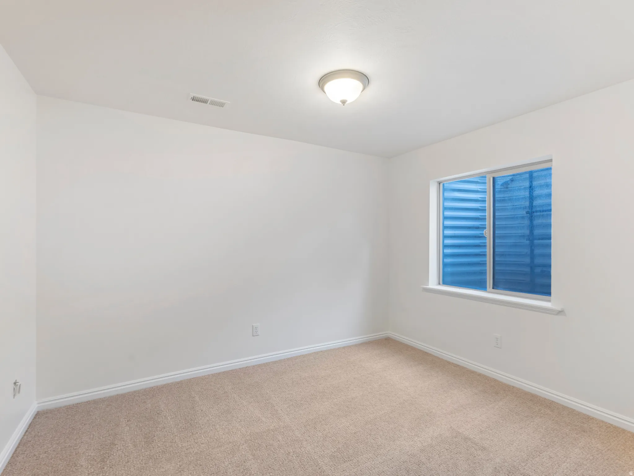 Neutral-toned carpeting paired with white baseboards