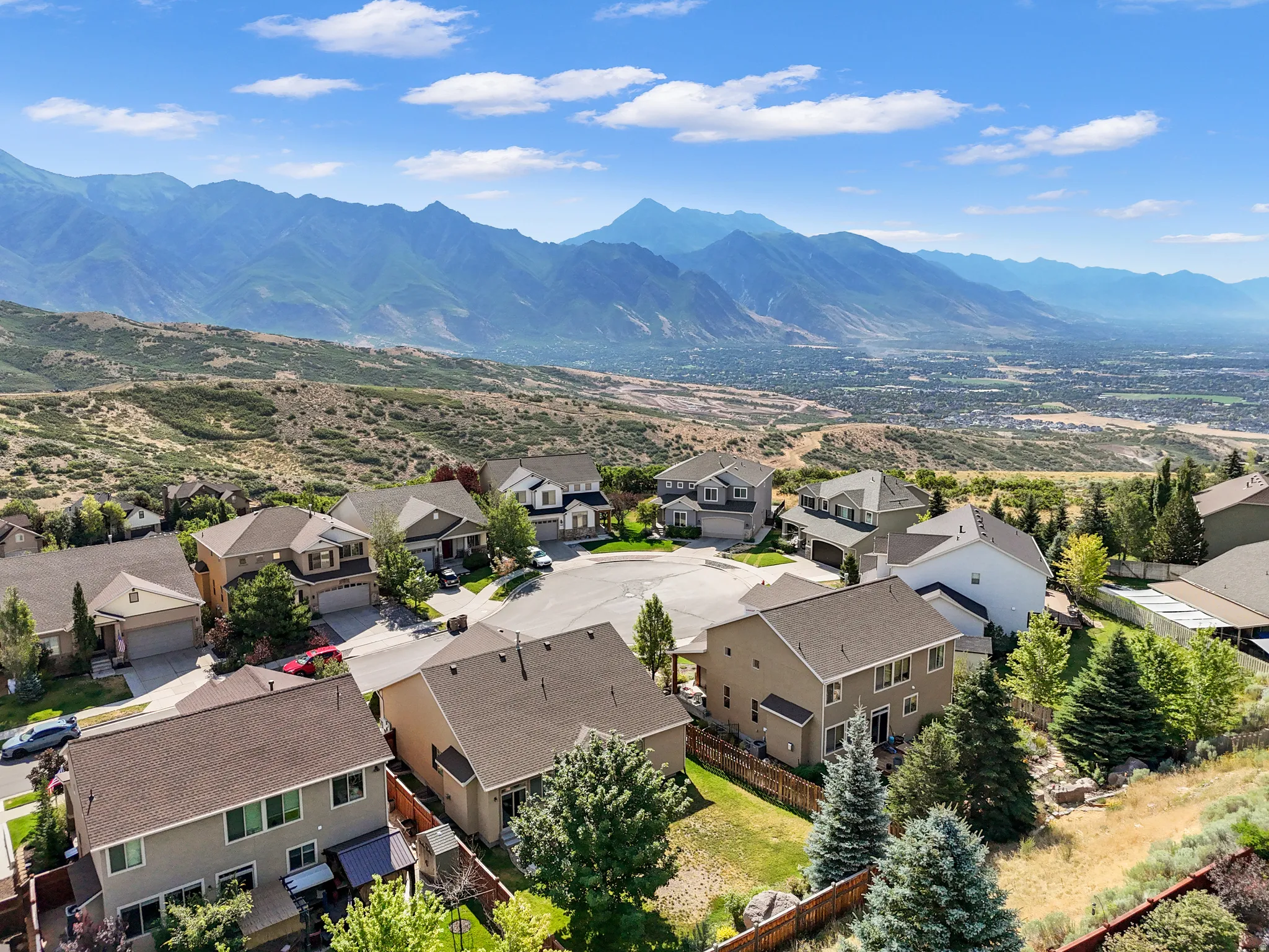 Residential neighborhood with an expansive mountain backdrop and distant valley scenery