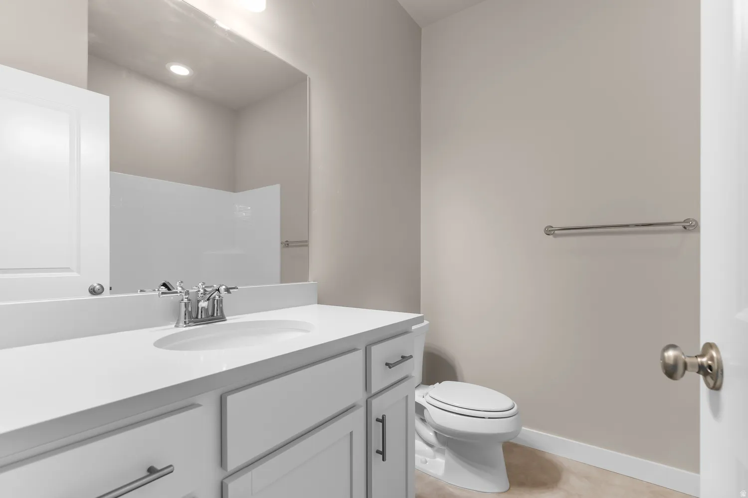 White vanity with brushed nickel pulls, integrated sink, and chrome faucet