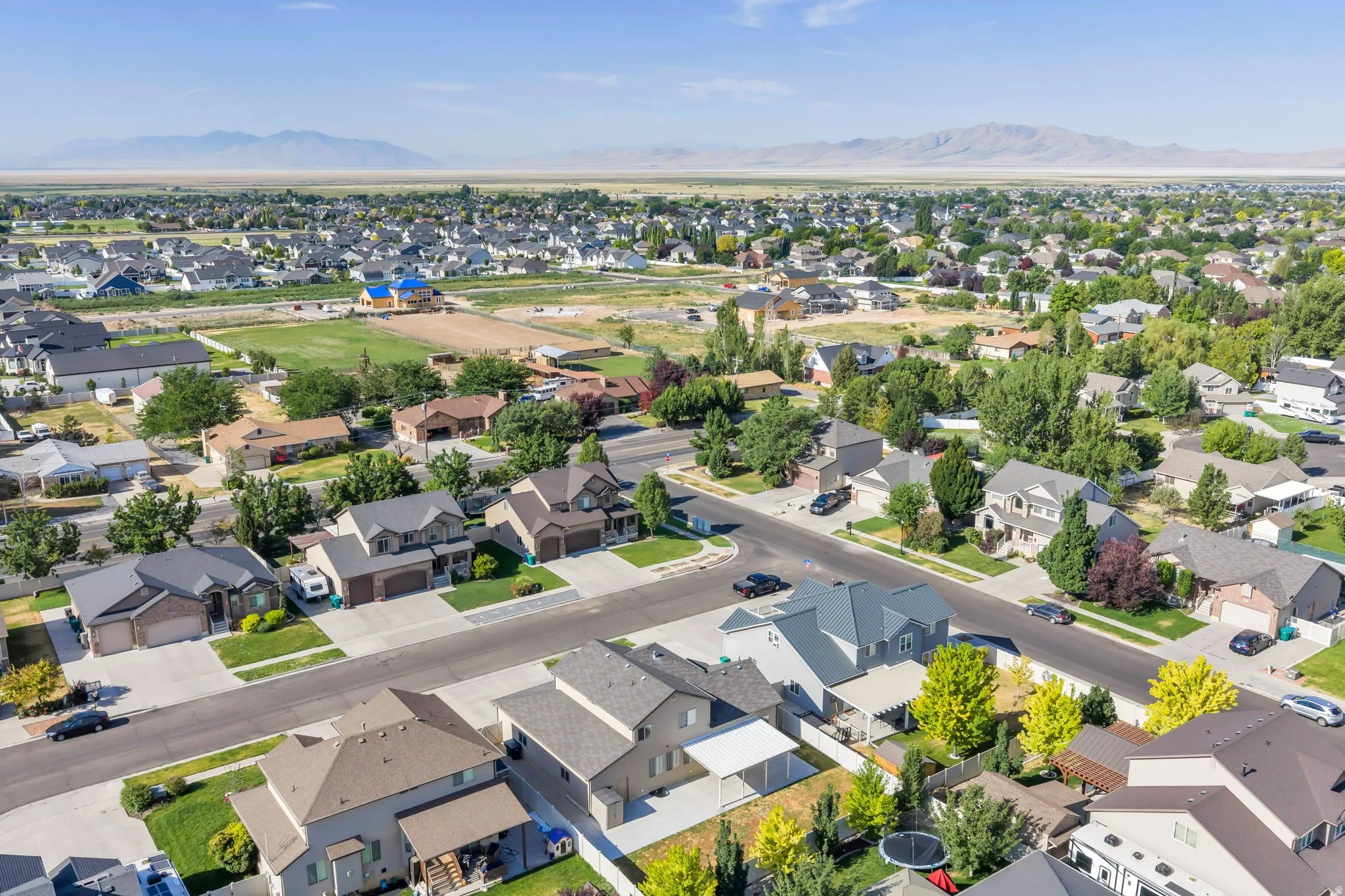 Expansive residential neighborhood featuring diverse architectural styles, mature landscaping, and paved streets