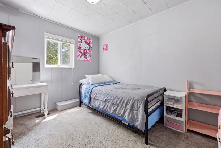 Wall-to-wall carpeting and neutral wall colors define this room