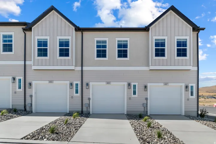Contemporary facade featuring stucco and vertical siding accents