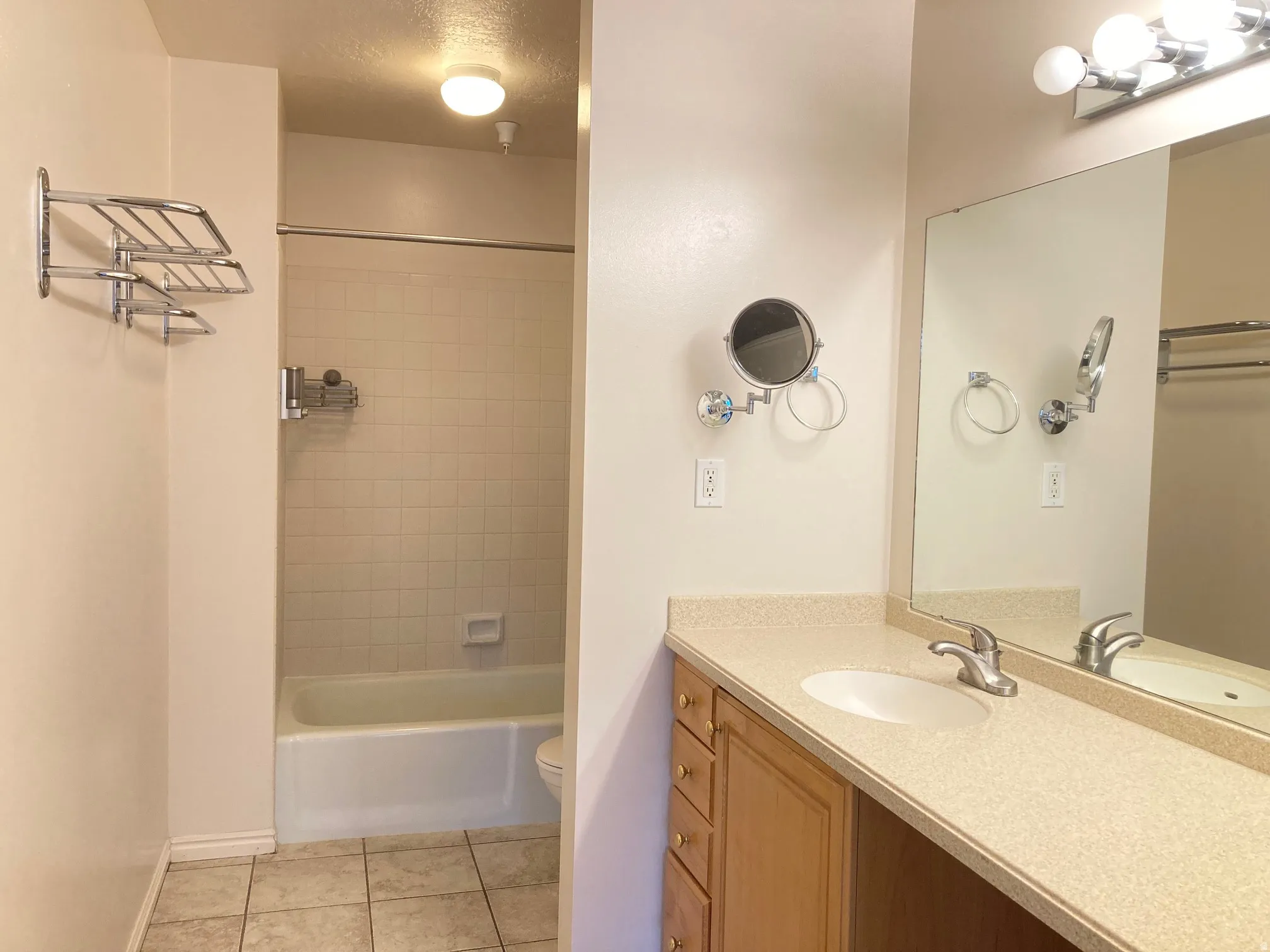 Bathroom vanity with an integrated sink and light-toned countertop