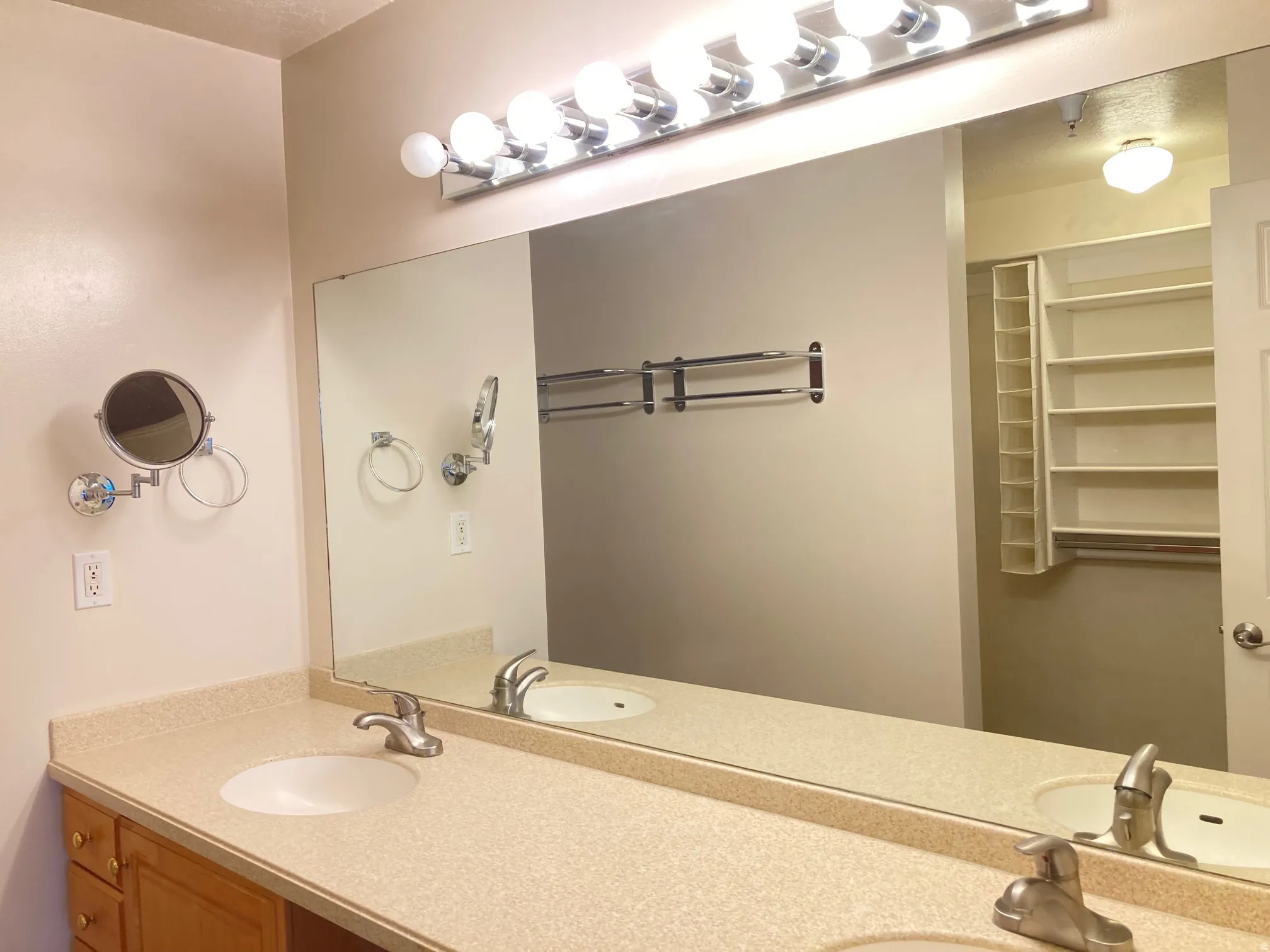 Double vanity featuring integrated sinks and a speckled countertop