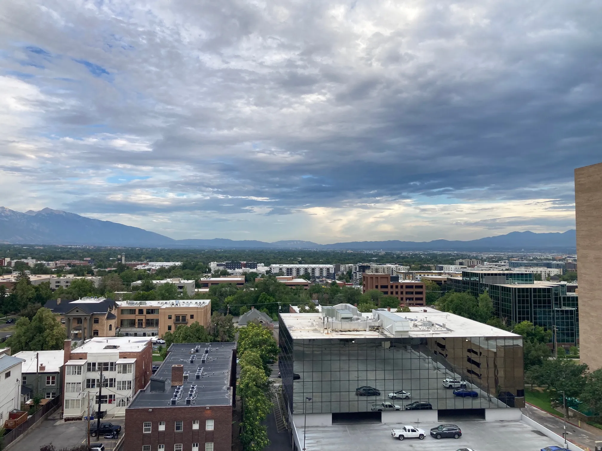 Expansive skyline and mountain backdrop featuring a diverse urban landscape with various architectural styles