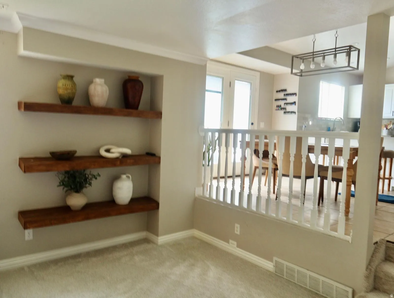 Built-in floating wooden shelves, white baseboards, and wall molding