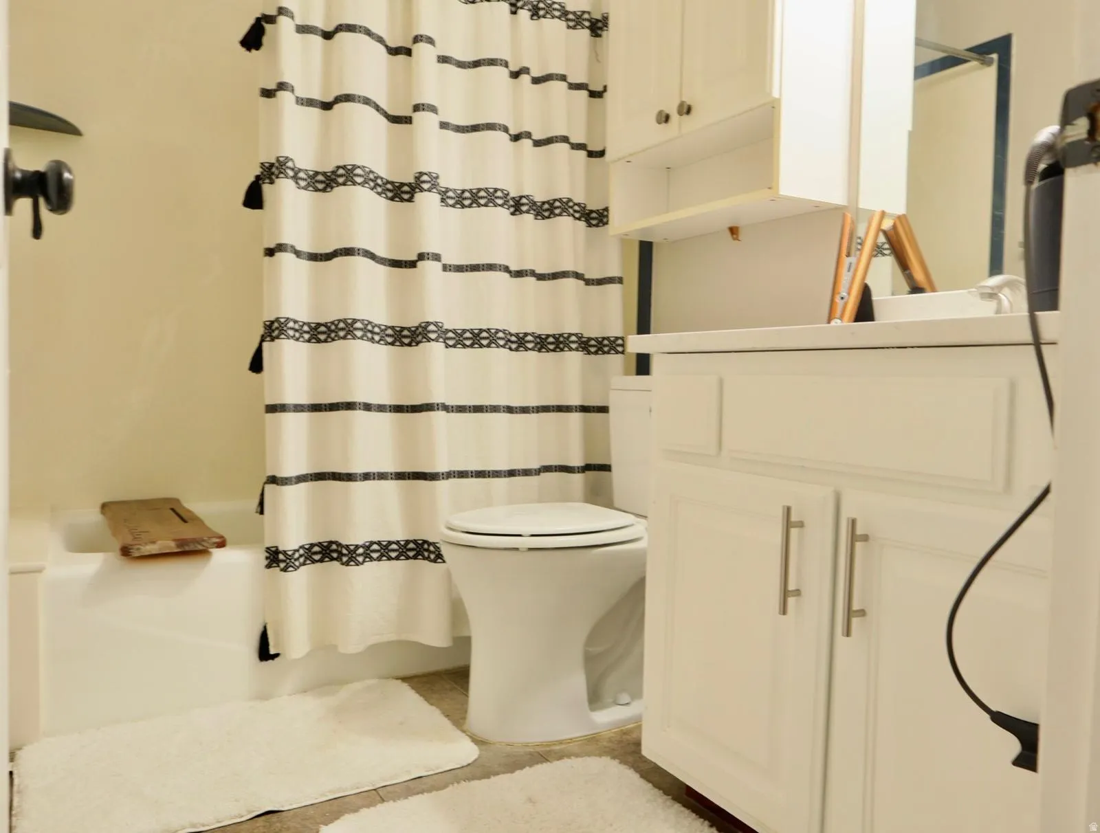 White vanity cabinetry featuring brushed nickel hardware