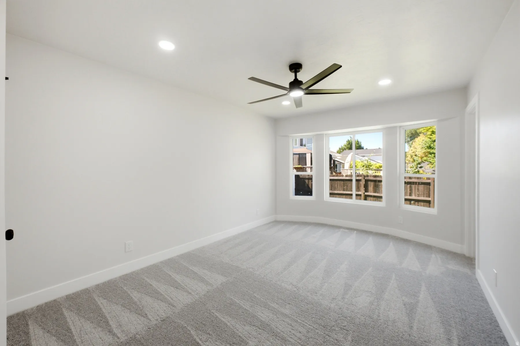 Bedroom featuring a bay window, recessed lighting, and a ceiling fan