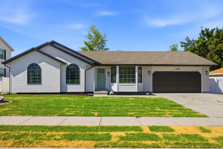 White siding exterior with a brown shingle roof