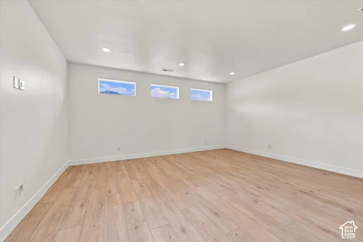Interior space featuring wood-finish flooring, recessed lighting, and a series of three horizontal clerestory windows