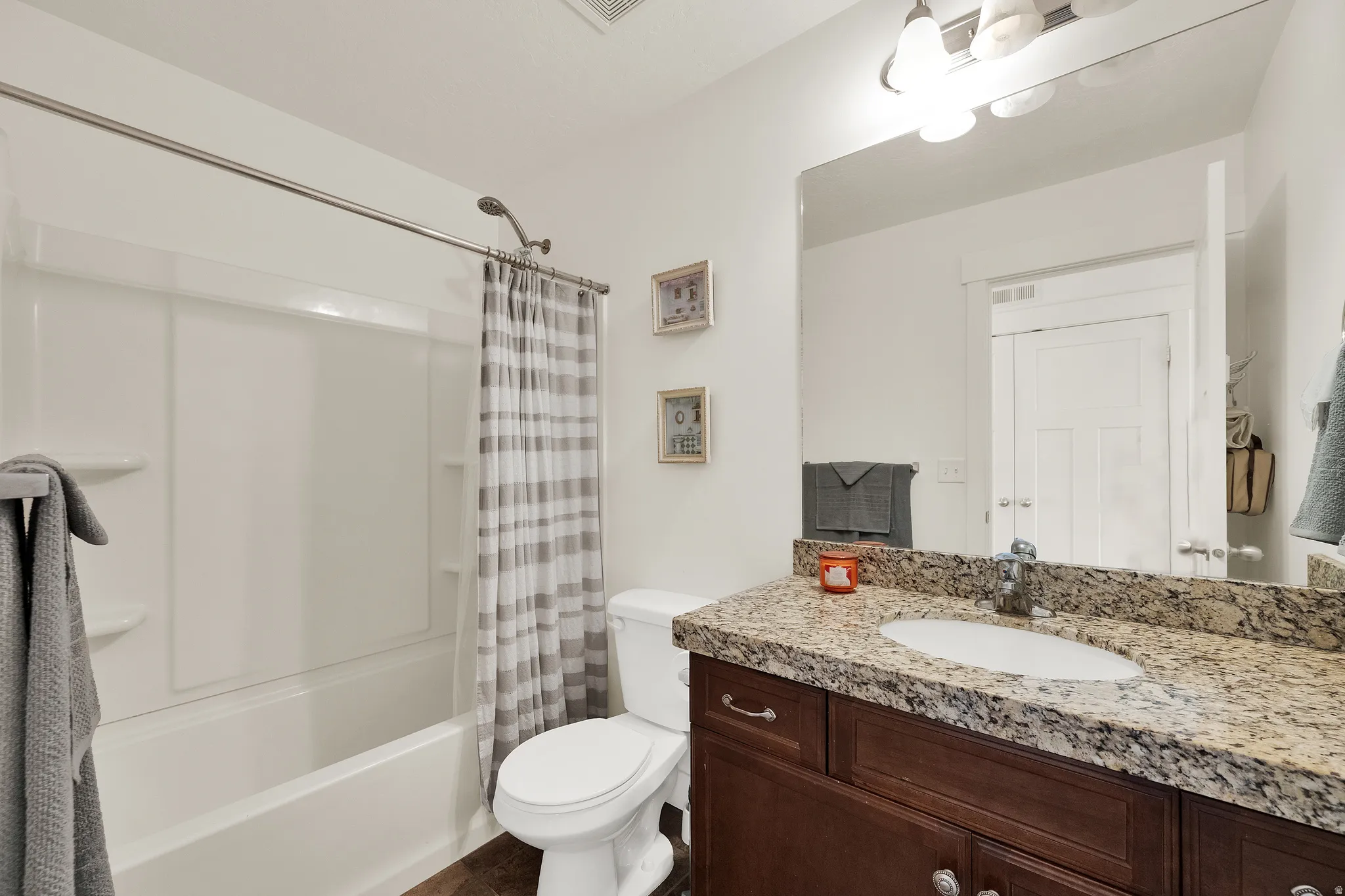 White bathtub and shower combination with a curved shower rod