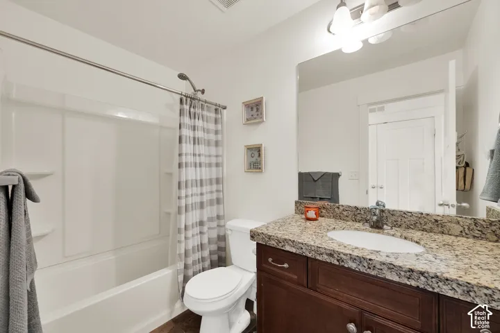 White bathtub and shower combination with a curved shower rod