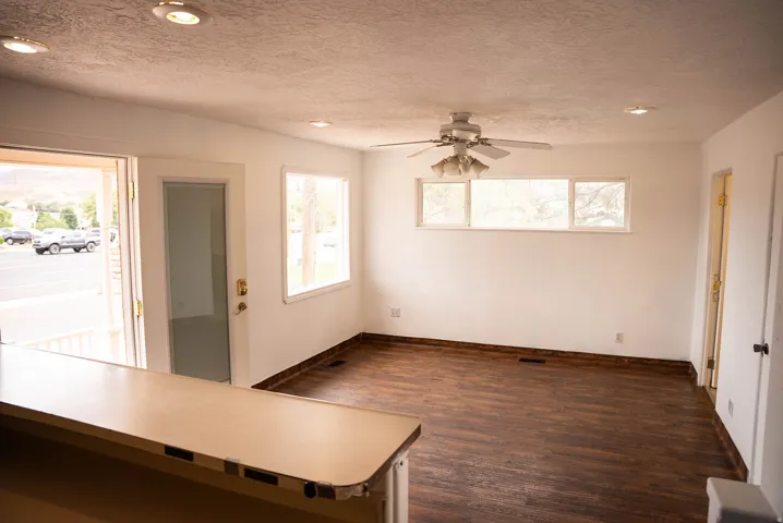 Bright interior space featuring wood-finish flooring and white walls