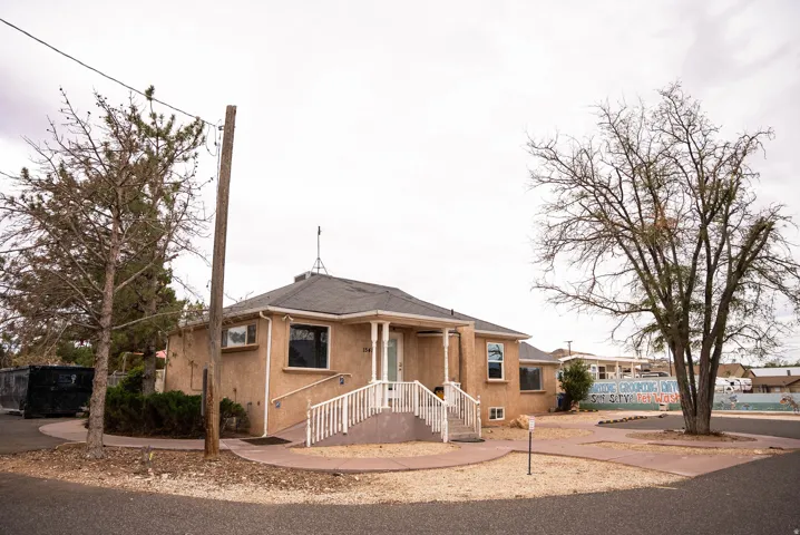 Stucco exterior with a hip roof and covered entry