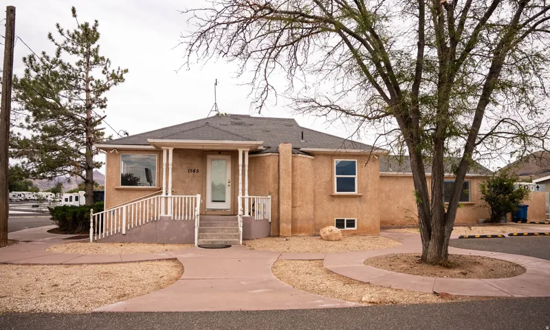 Stucco exterior with a covered porch entry