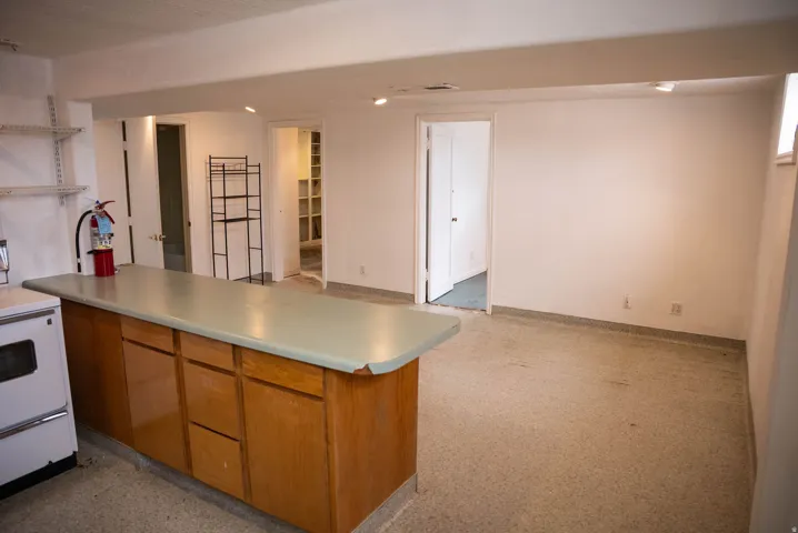 Island with wood-finish cabinetry and a light-colored countertop