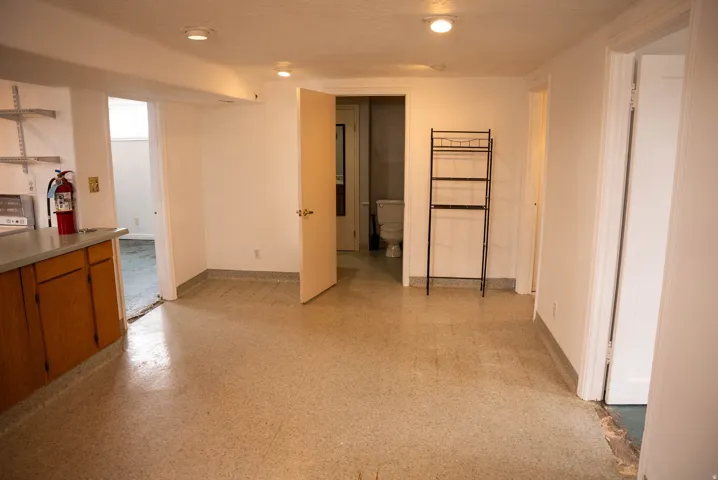 Spacious area featuring light-toned flooring, recessed ceiling lighting, and solid core doors