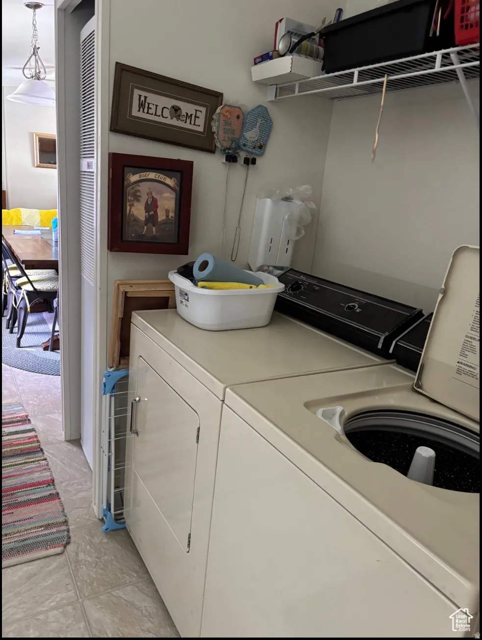 Dedicated laundry area featuring a top-load washing machine and front-load dryer