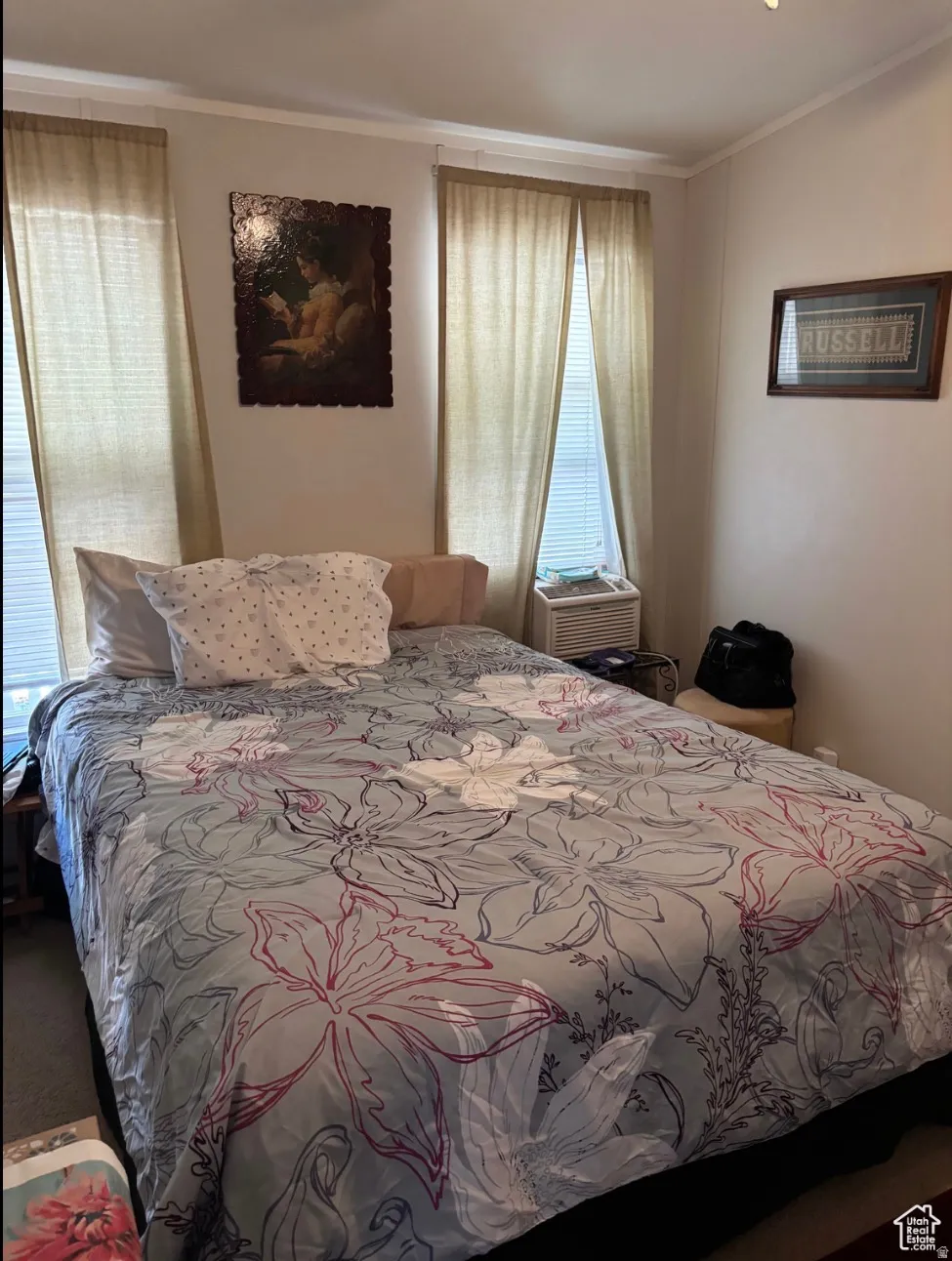 Bedroom featuring white walls and crown molding