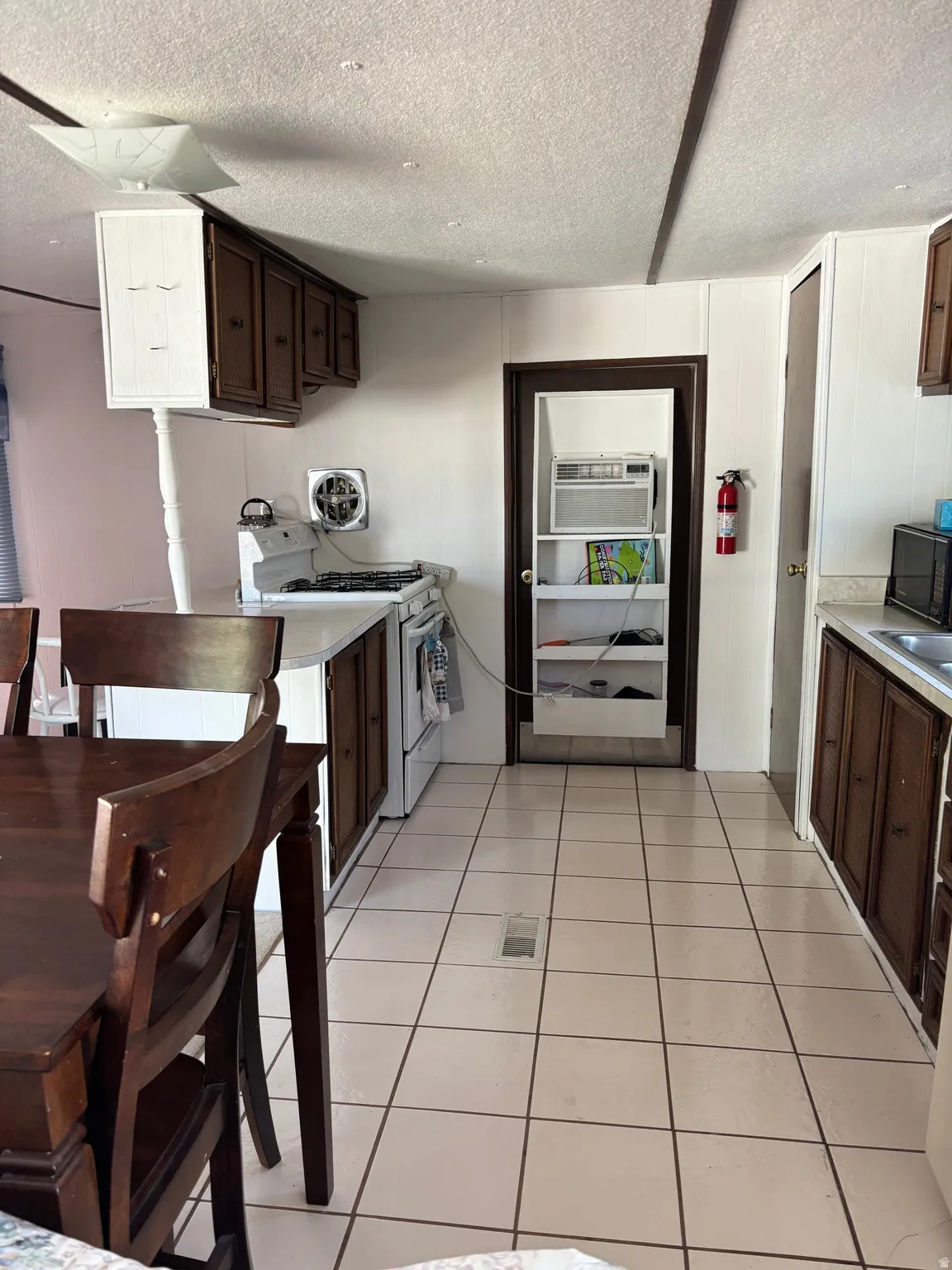Kitchen area featuring light-toned tile flooring throughout