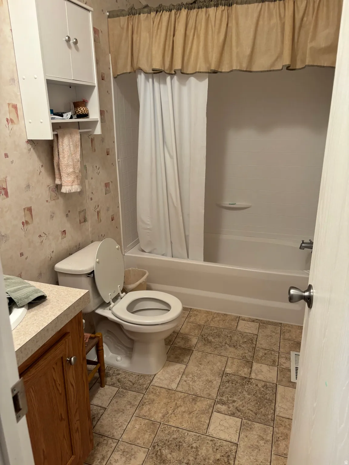 Bathroom featuring a full tub and shower combination