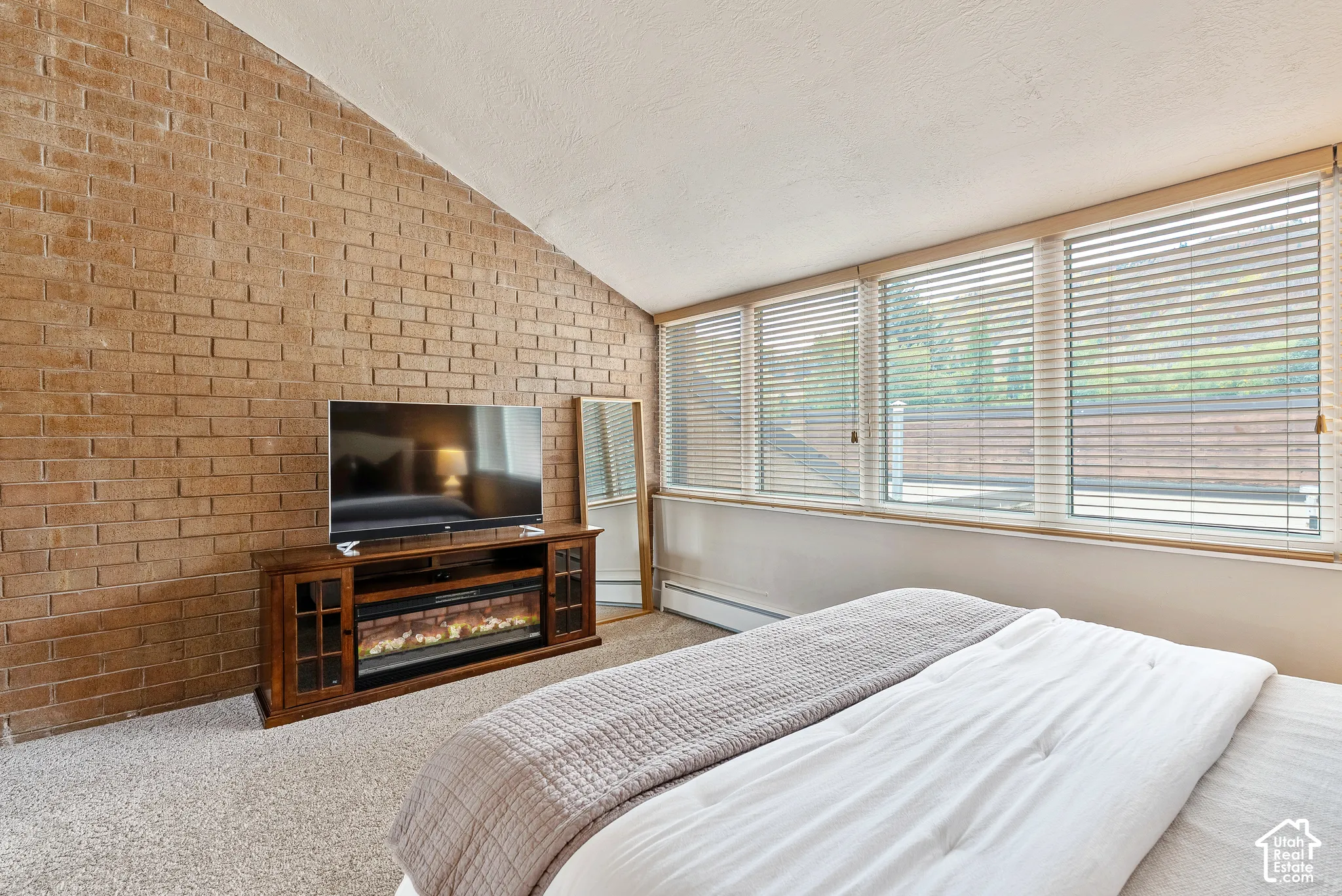 Interior brick accent wall with a vaulted ceiling