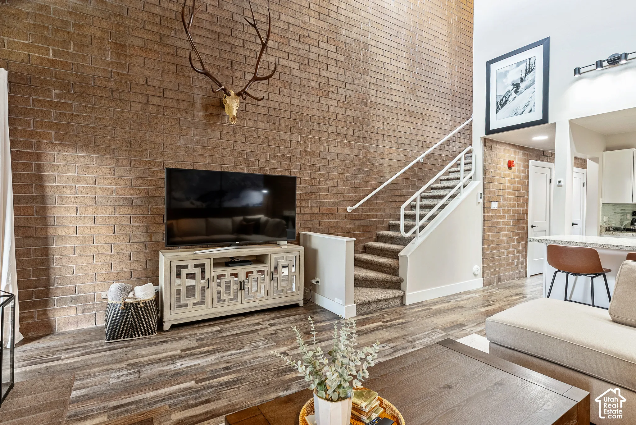 Two-story brick accent wall with wood-finish flooring