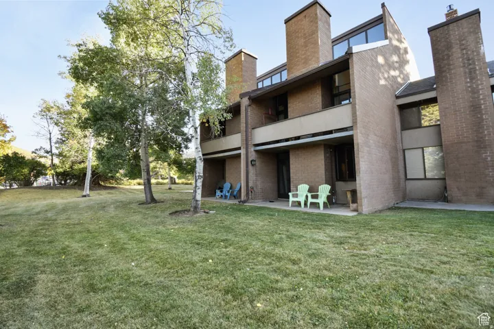 Brick facade building featuring multiple levels with balconies and patios