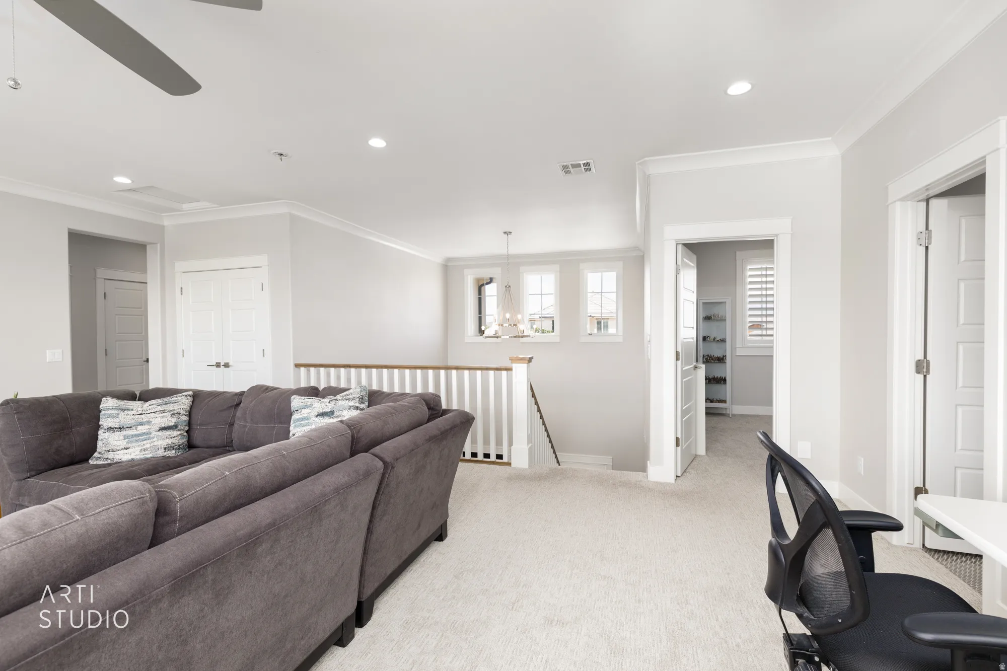 Carpeted loft area featuring recessed lighting, crown molding, and a ceiling fan