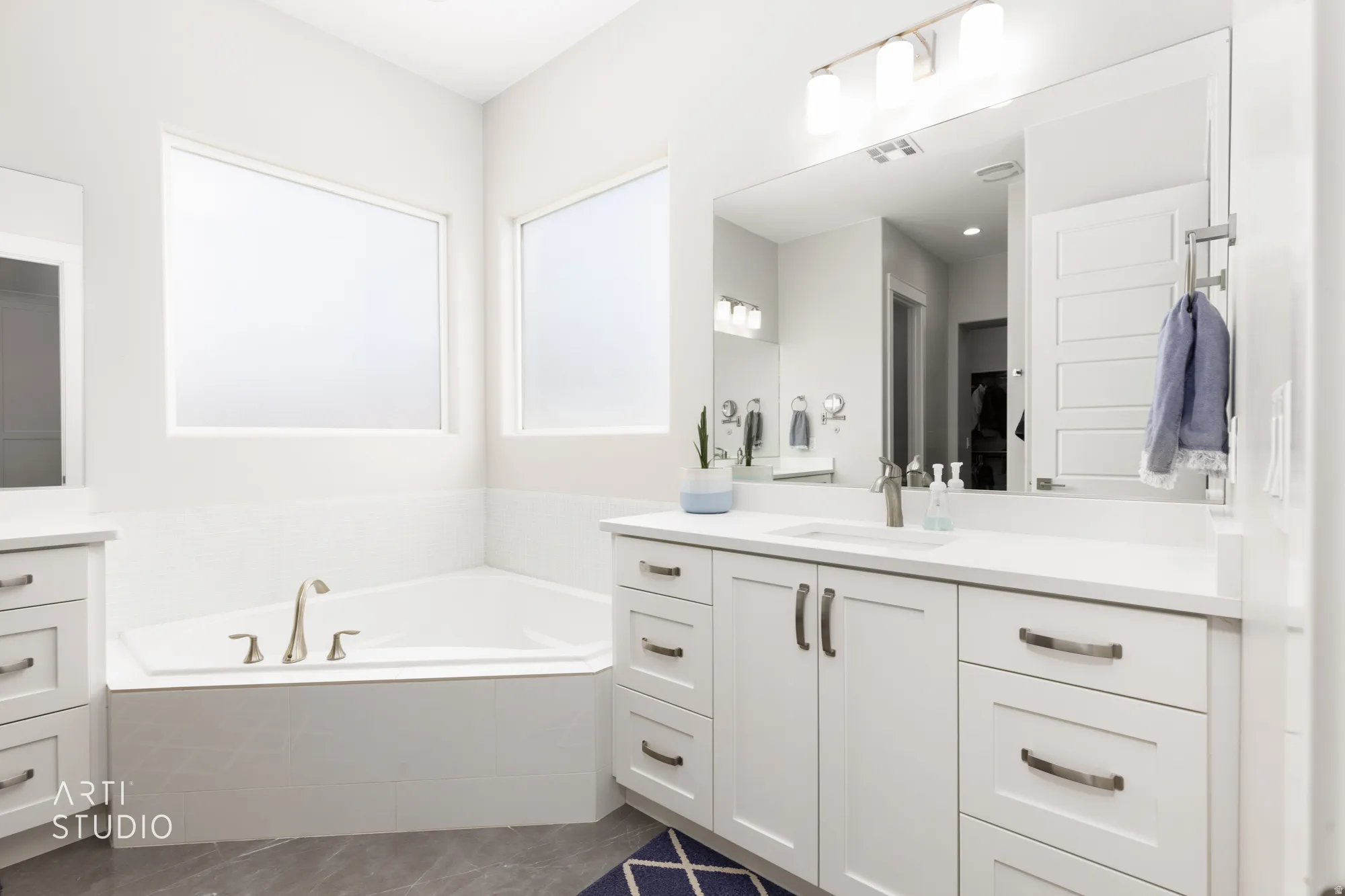 Corner soaking tub with brushed nickel fixtures