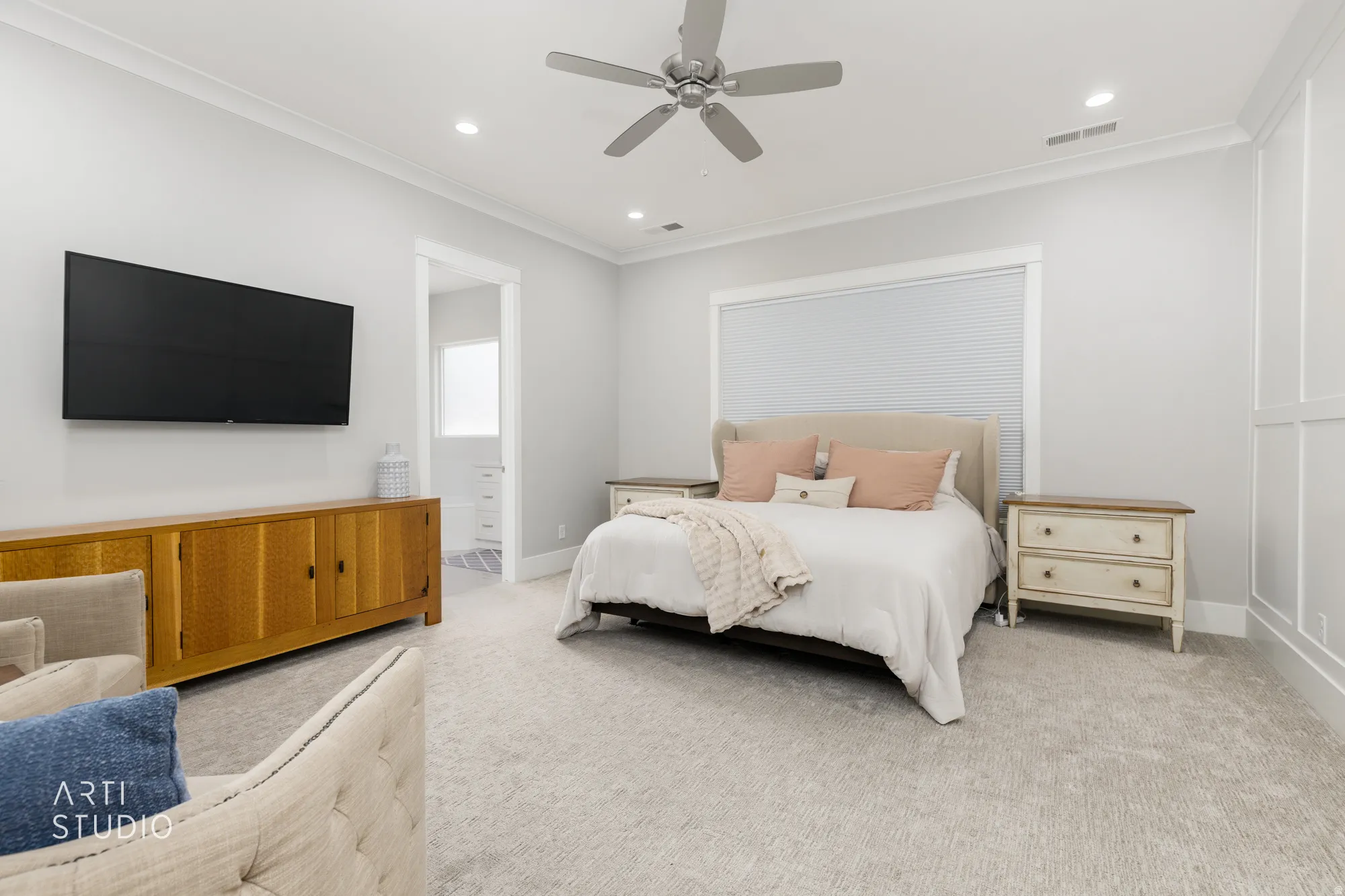Spacious room featuring neutral carpeting and a ceiling fan