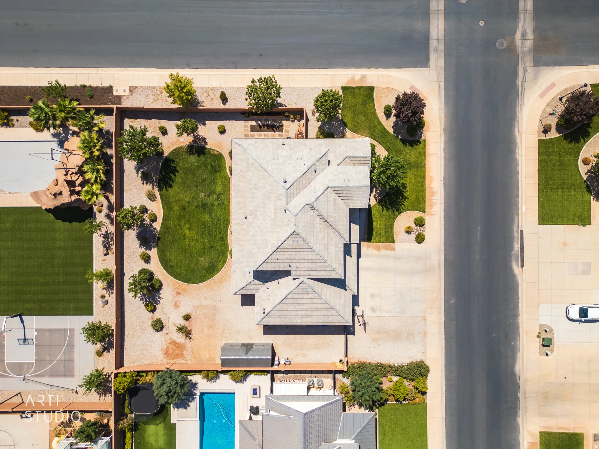 Expansive property featuring a multi-gabled main residence, a private swimming pool, and a dedicated sport court