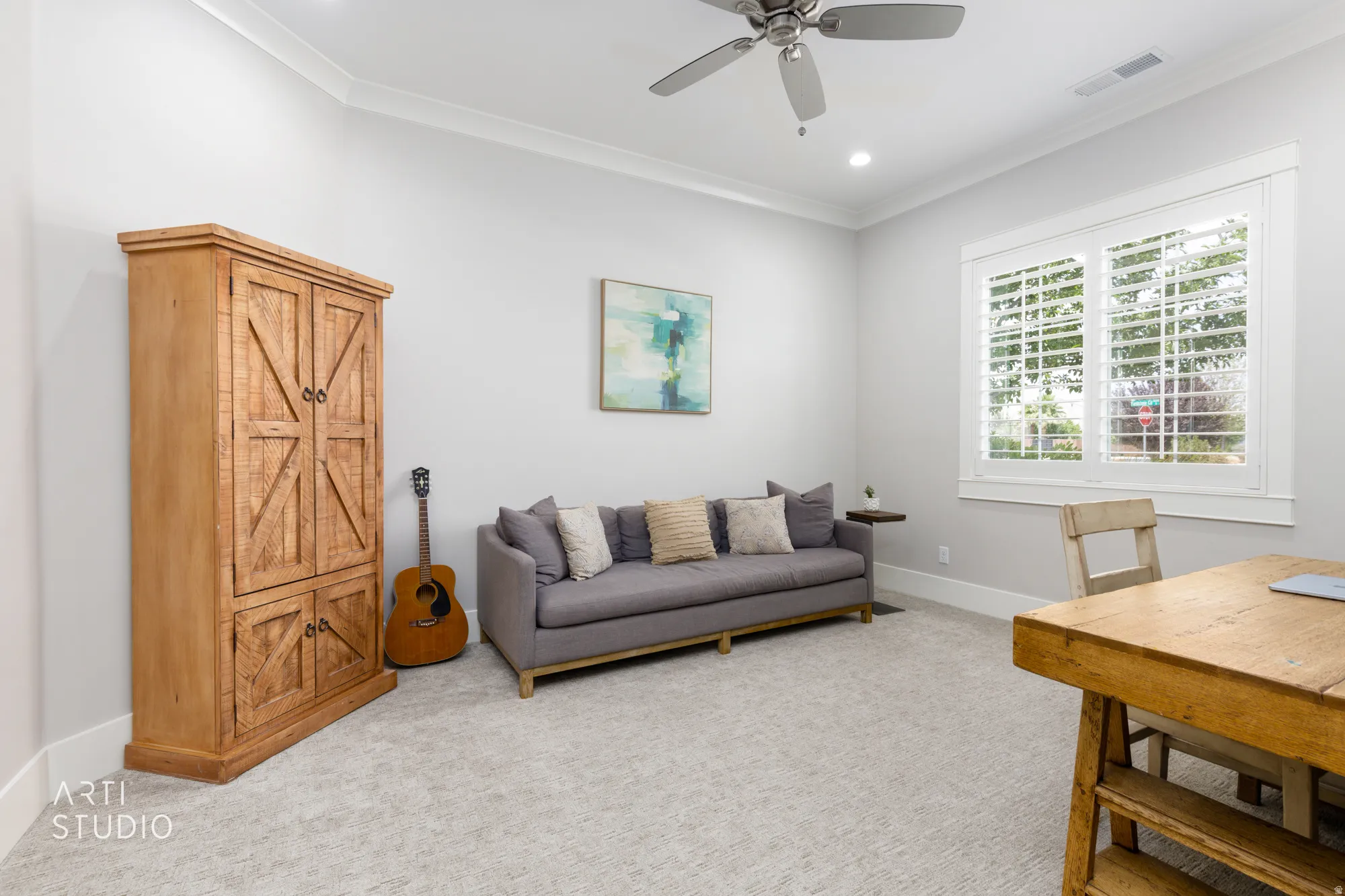 Spacious room featuring light-colored carpeting, white crown molding, recessed lighting, and a ceiling fan