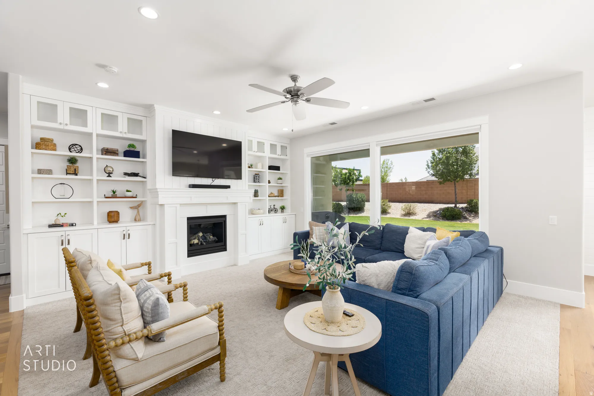 Living area featuring a fireplace with a white mantel, built-in shelving, and shaker-style cabinetry
