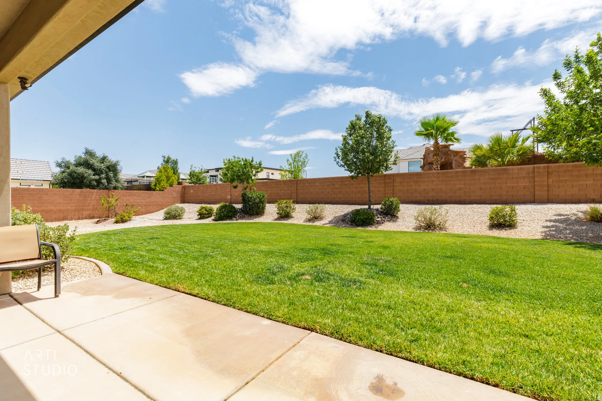 Expansive grass lawn with a concrete patio