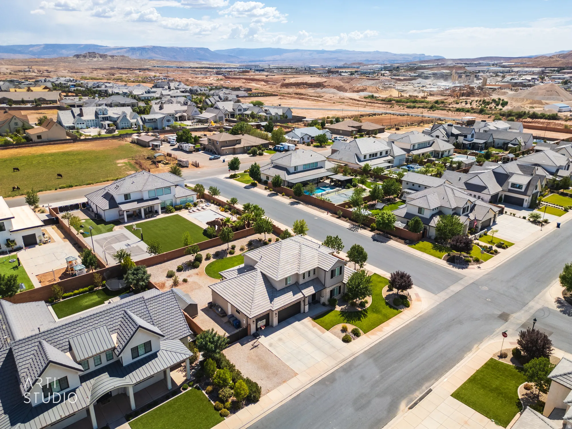 Aerial perspective of a residential neighborhood featuring paved streets and manicured landscaping